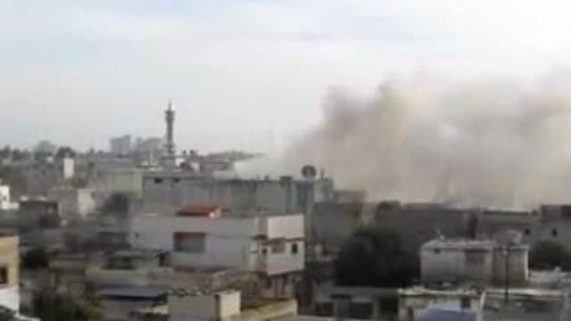 Smoke rises from the skyline in Homs, Syria 