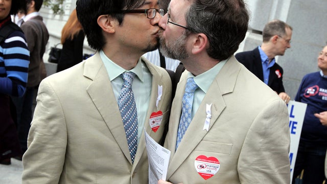 Same-sex couple Jeff Tabaco, left, and Thom Watson kiss as they hold paperwork for a marriage license Aug. 12, 2010, in San Francisco. 