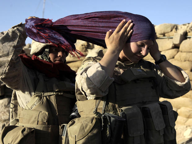 U.S. Marine Sgt. Monica Perez, of San Diego, left, helps Lance Cpl. Mary Shloss of Hammond, Ind., put on her head scarf before heading out on a patrol in the village of Khwaja Jamal, Afghanistan, Aug. 10, 2009. 