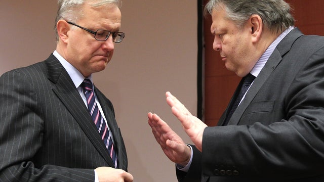 European Commissioner for Economic and Monetary Affairs Olli Rehn, left, talks with Greek Finance Minister Evangelos Venizelos 