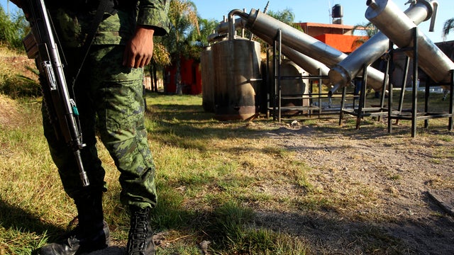 A soldier stands in what was identified as "metal reactors" after a seizure of a large clandestine methamphetamine lab at a ranch in Tlajomulco de Zuniga, Mexico, Feb. 9, 2012. According to the Mexican army, 15 tons of pure methamphetamine were seized at  