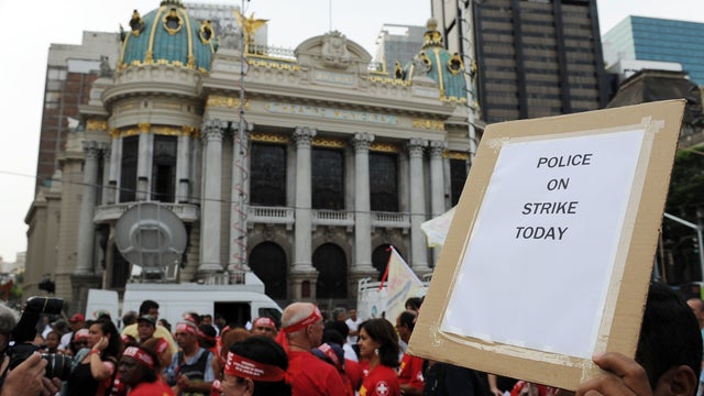 Policemen and firefighters stand in protest along the historic center of Rio de Janeiro, Brazil on February 9, 2012.  