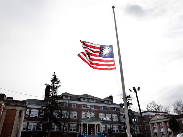 An American flag flies at half-staff in front of The Whitney E. Houston Academy of Creative and Performing Arts in East Orange, NJ 