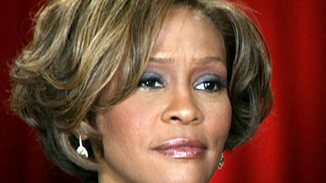 Whitney Houston sits with Oprah Winfrey in 2009. 