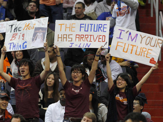 Fans of Jeremy Lin hold up signs  