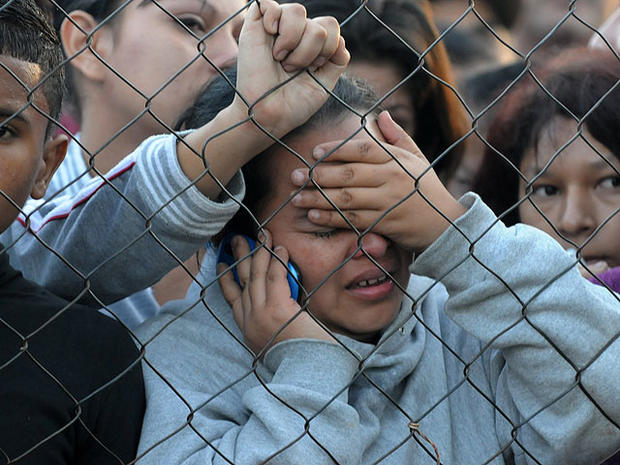 Relatives of inmates await outside the National Prison of Comayagua compound in Comayagua, Honduras, on February 15, 2012, where hundreds of prisioners were killed and scores injured when fire overnight tore through the prison in central Honduras. 