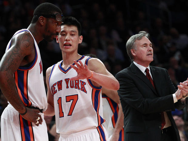 Jeremy Lin talks to teammate Amare Stoudemire as head coach Mike D'Antoni calls out to the team 