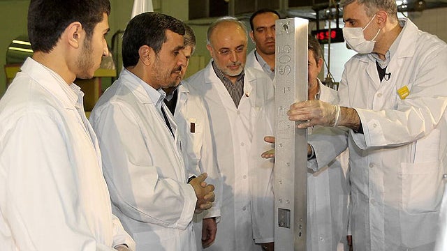 This photo released by the Iranian President's Office, claims to show Iranian President Mahmoud Ahmadinejad, second left being escorted by technicians during a tour of Tehran's research reactor centre in northern Tehran, Iran, Feb. 15, 2012.  