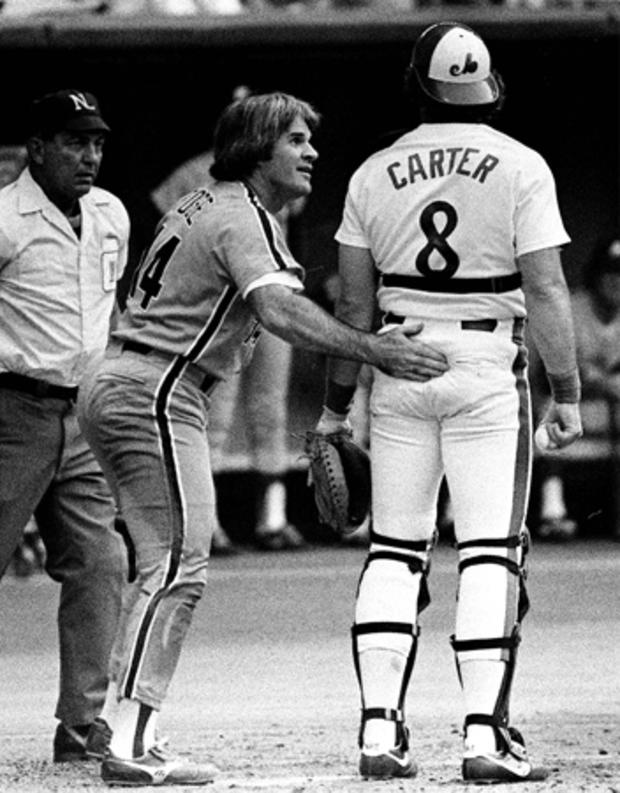 Pete Rose gives Montreal Expos catcher Gary Carter a pat 