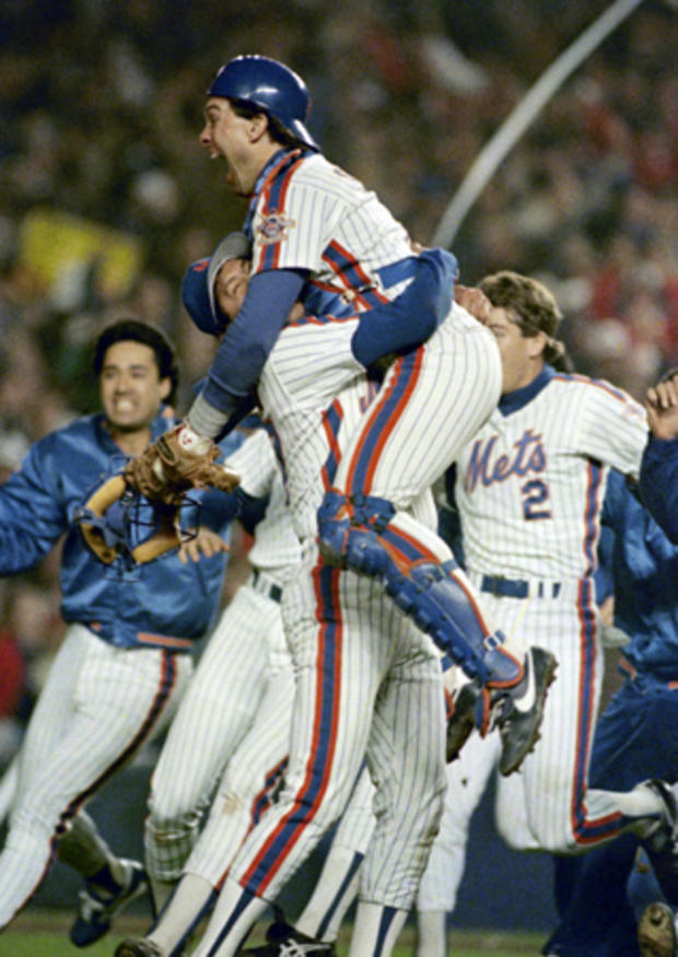 Gary Carter is lifted in the air by relief pitcher Jesse Orosco 