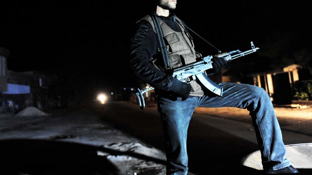 A Free Syrian Army fighter stands guard in Idlib, Syria, near the Turkish border, Feb. 19, 2012. 