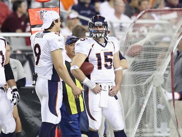 GLENDALE, AZ - DECEMBER 12: Quarterbacks Brady Quinn #9 and Tim Tebow #15 of the Denver Broncos stand on the sideline during the NFL game against the Arizona Cardinals at the University of Phoenix Stadium on December 12, 2010 in Glendale, Arizona. The Cardinals defeated the Broncos 43-13. (Photo by Christian Petersen/Getty Images) 