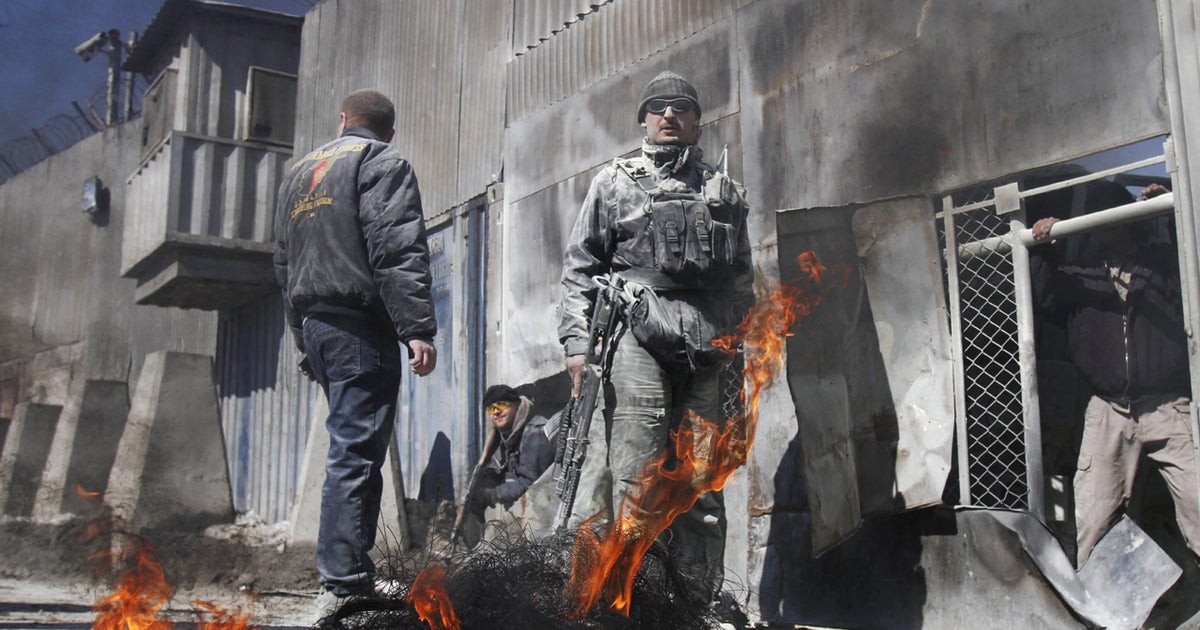 U.S. Embassy locked down amid violent protests - CBS News