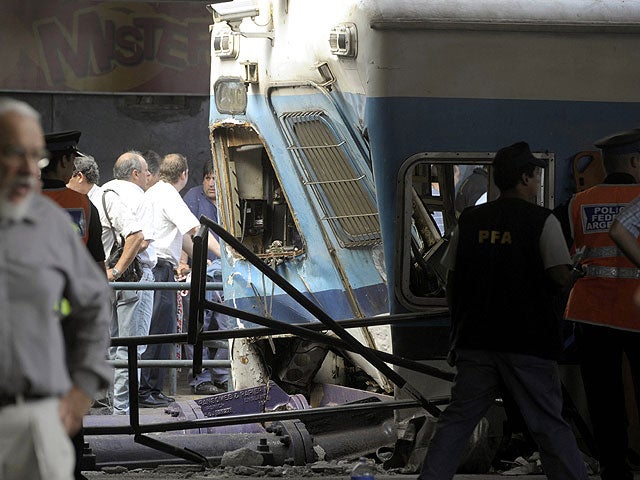 Police and rescue workers surround a train that crashed at Once train station in Buenos Aires on February 22, 2012.