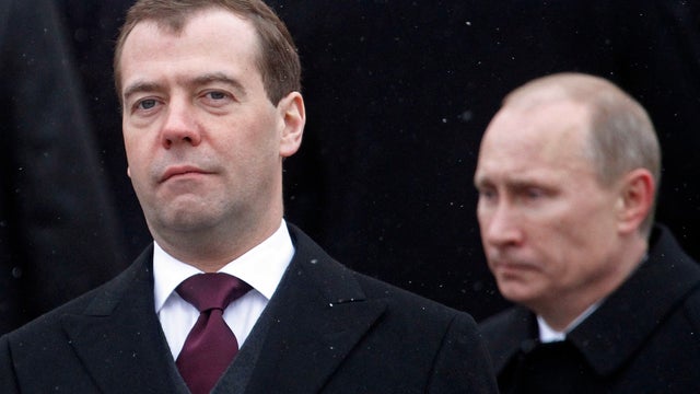 Russian President Dmitry Medvedev, left, and Prime Minister Vladimir Putin , right, are seen during a wreath-laying ceremony in Moscow, Russia, Thursday, Feb. 23, 2012.  