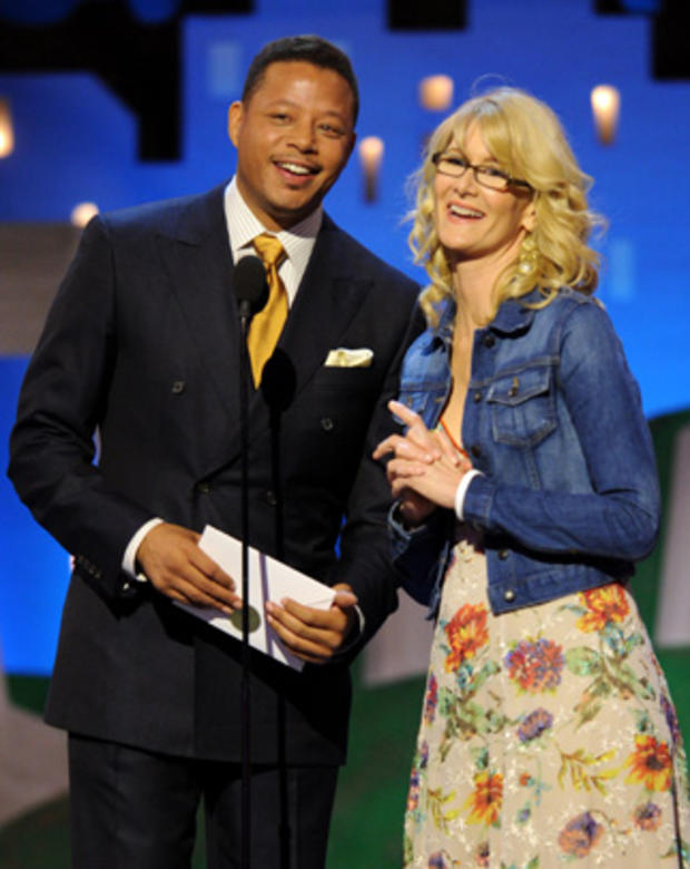 Terrence Howard, left, and Laura Dern speak onstage at the Independent Spirit Awards 