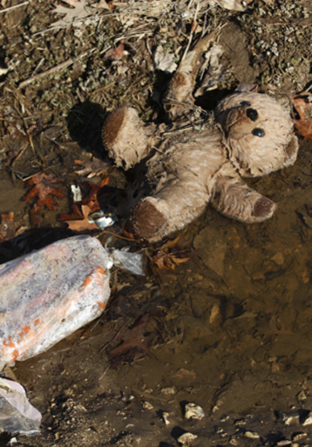 A stuffed toy lies in a ditch the morning after severe storms  