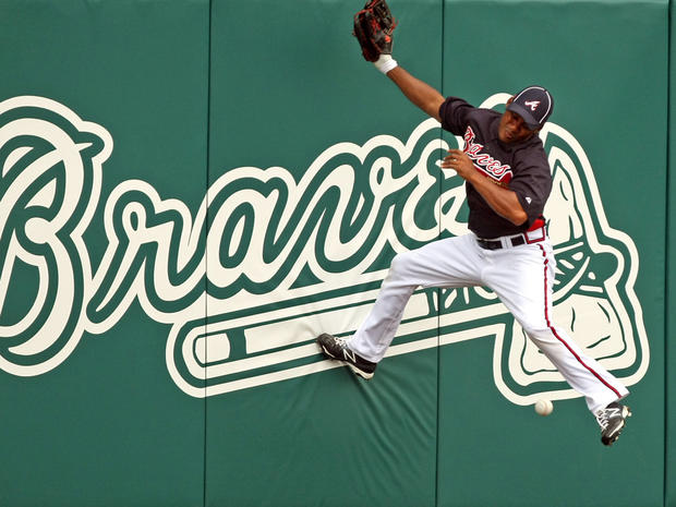 Jose Constanza can't make the grab as he crashes into the outfield wall 