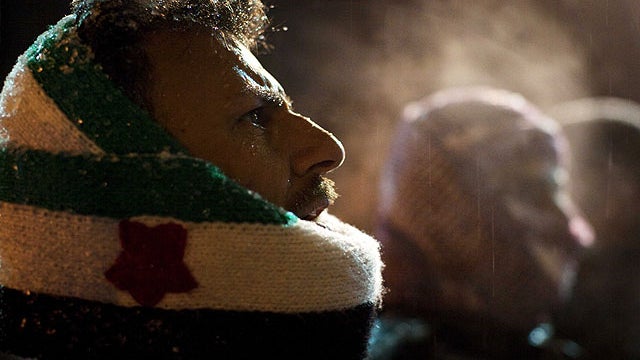 Free Syrian Army supporters chant anti government slogans under snowfall on the outskirts of Idlib , north Syria, Feb. 29, 2012.  