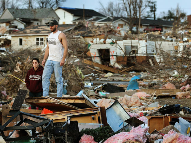 Josh Summers and his wife Lindsey search for their possessions after a tornado 