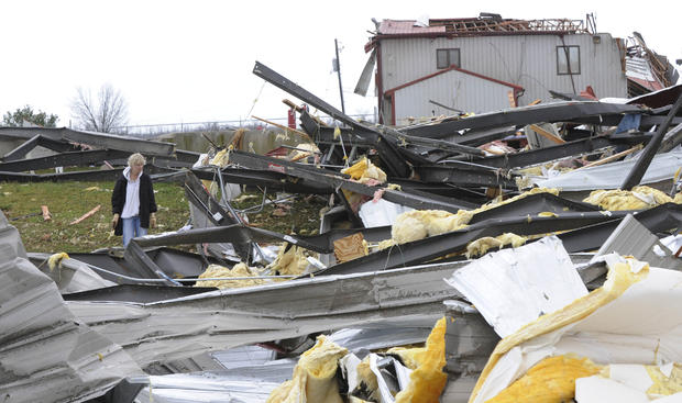 Cathy Riggs looks for her belongings after a tornado struck  