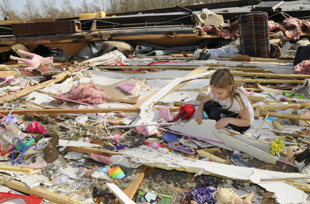 Sierra Gaines, 8, sifts through the remains of her family's mobile home 