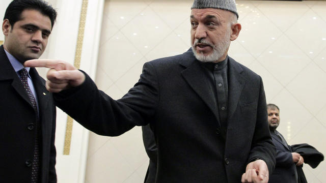 Afghan President Hamid Karzai gestures toward a journalist, not pictured, at the end of his press conference at the presidential palace in Kabul, Afghanistan, Feb. 26, 2012. 