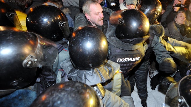 Police officers detain opposition activists at Moscow's Pushkinskaya Square March 5, 2012, as they refuse to leave the venue at the end of their larger rally earlier. 