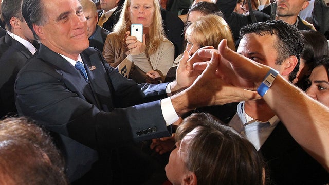 Former Massachusetts Gov. Mitt Romney greets supporters at a Super Tuesday night gathering with his family at the Westin Copley Place March 6, 2012, in Boston. 
