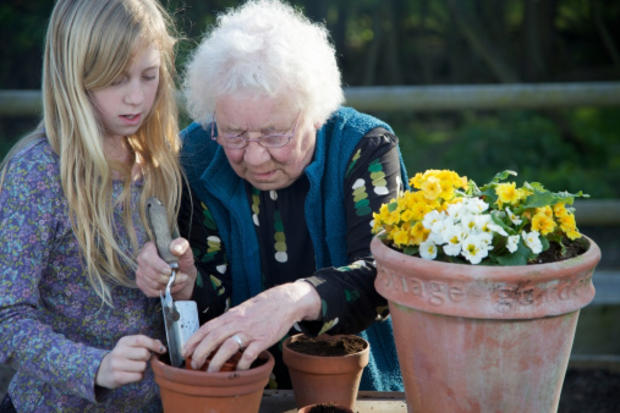 Girl Gardening with Elderly Woman 