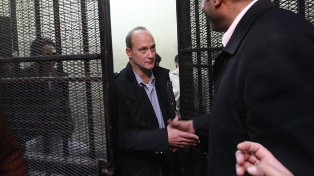 Egyptian protesters chant anti-military ruling slogans during a trial of employees of pro-democracy groups charged with using foreign funds to foment unrest in Cairo, Egypt, Feb. 26, 2012.  