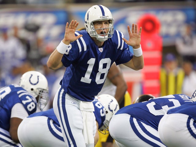 Peyton Manning calls out signals at the line 
