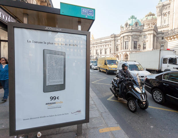 This advertisement for an Amazon Kindle stood on a bus stop a few feet away from the Apple store where hundreds had queued to buy a third-generation iPad tablet instead. 