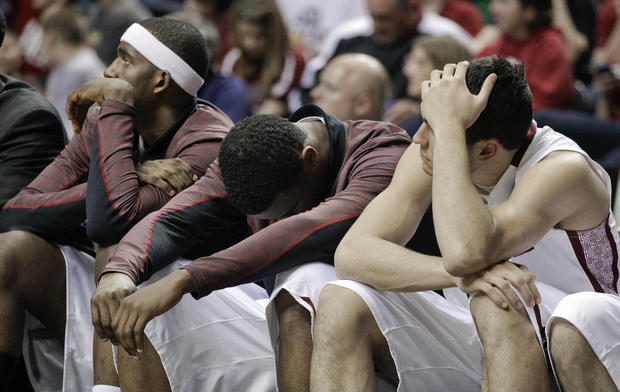 Temple players Anthony Lee, left, Scootie Randall, center, and T. J. DiLeo, right, wait out the final minutes  