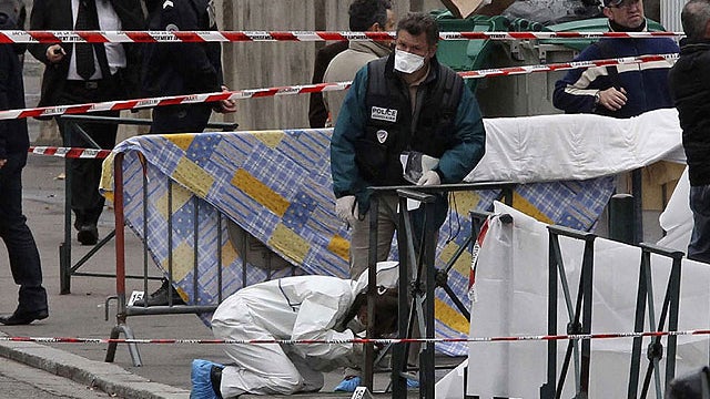 Police officers gather at the site of a shooting in Toulouse, southwestern France, March 19, 2012.  