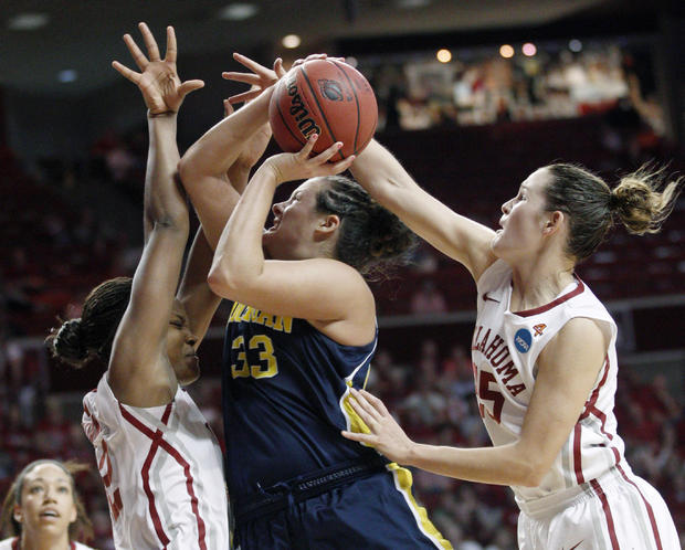 Carmen Reynolds  is fouled by Oklahoma guard Whitney Hand 