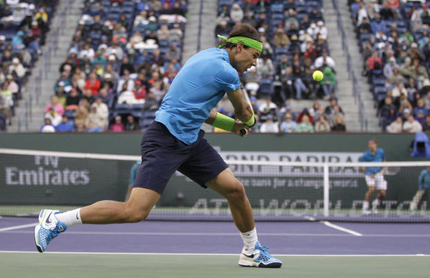 Rafael Nadal returns a shot to Roger Federer 