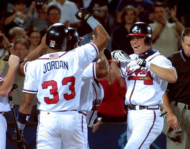 Chipper Jones celebrates at home plate after he hit a grand slam 