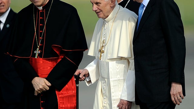 Pope Benedict XVI, flanked by Vatican secretary of state Cardinal Tarcisio Bertone, left, and Italian Premier Mario Monti, boards a plane on his way to Mexico and Cuba March 23, 2012, at Rome's Leonardo da Vinci airport. 