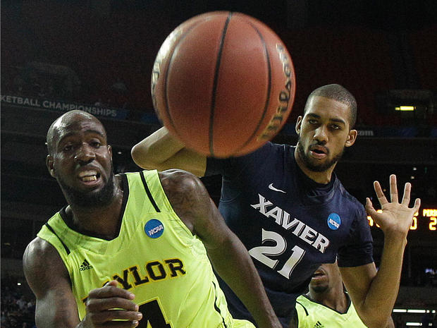 Baylor's Quincy Acy (4) and Xavier's Jeff Robinson (21) vie for a loose ball  