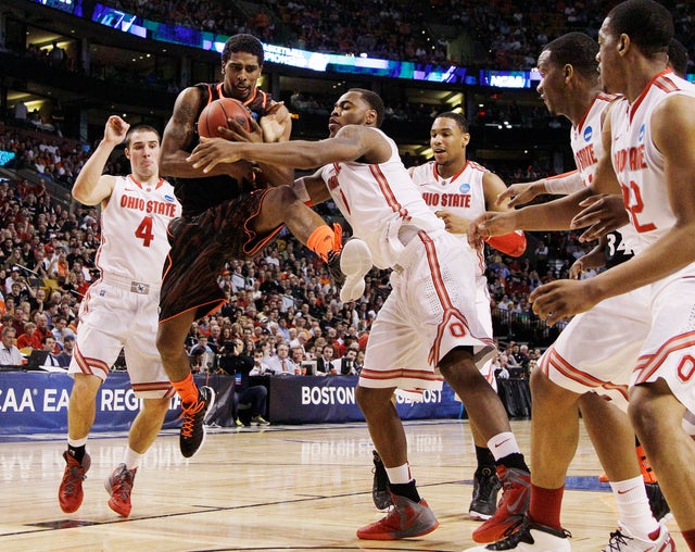 Jaquon Parker tries to drive Aaron Craft and forward Deshaun 
