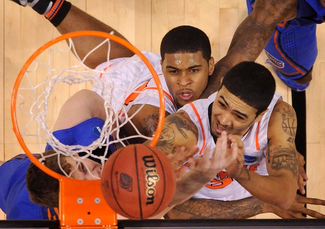 Peyton Siva and Erik Murphy battle for a rebound  