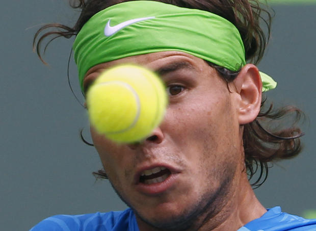 Rafael Nadal keeps his eye on the ball as he returns a shot from Kei Nishikori 