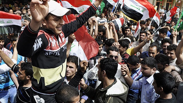 People chant pro-Arab Summit slogans during a demonstration in Fallujah, 40 miles west of Baghdad, Iraq, March 27, 2012.  