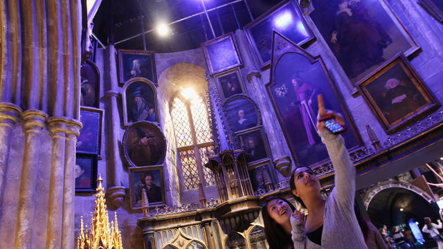 Two girls look around the set of Dumbledore's office at the new Harry Potter Studio Tour 