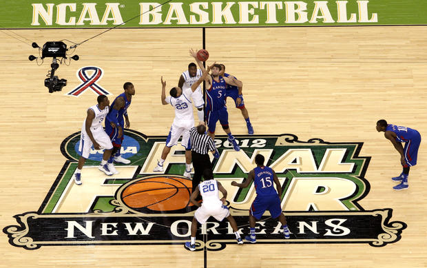 Kentucky forward Anthony Davis (23) and Kansas center Jeff Withey (5) jump for the opening tip-off  