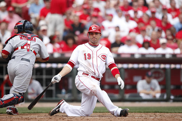 Joey Votto falls to his knees after swinging and missing a pitch  