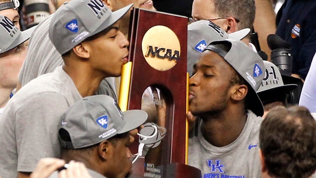 Anthony Davis, left, and  Michael Kidd-Gilchrist, right, kiss the trophy  
