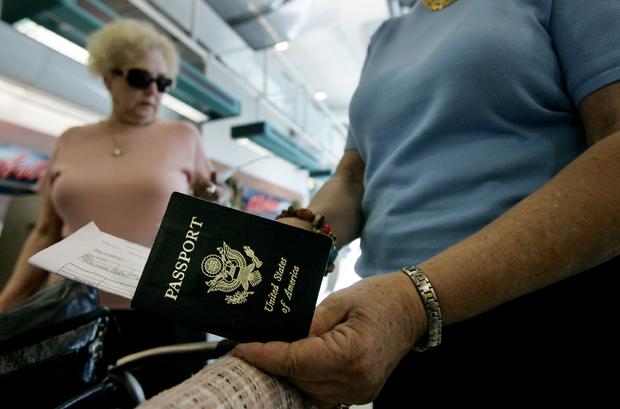 Travelers take out their passports before checking in airport 