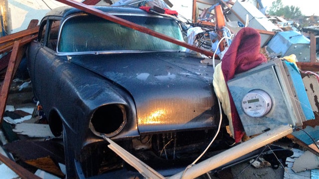 A vehicle is covered in tornado debris in Dallas 